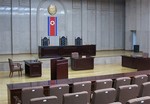 File - In this March 20, 2013 photo, a North Korean flag hangs inside the interior of Pyongyang’s Supreme Court. Detained American Kenneth Bae has been condemned to 15 years of hard labour for 'hostile acts' against the state.