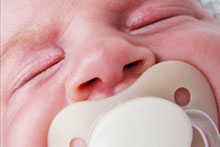 Baby with a dummy (iStockphoto)