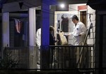 Members of the FBI evidence team remove items from a house on in Cleveland Monday, May 6, 2013. Three women who went missing separately about a decade ago, when they were in their teens or early 20s, were found alive in the house, and a man was arrested.