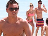 Tom Daley and Tonia Couch enjoy some downtime on the beach as they take a break from Grand Prix diving training in Florida