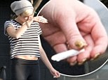 Miley Cyrus ditches her healthy lifestyle as she's caught smoking a cigarette and chowing down on fast-food 