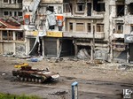 This citizen journalism image provided by Lens Young Homsi, which has been authenticated based on its contents and other AP reporting, shows a destroyed Syrian tank seen at al-Qossur neighborhood in Homs province, Syria, Monday, May 13, 2013.