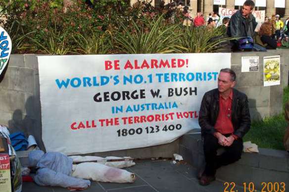Banner urging to call the terrorist hotline - Bush in town
