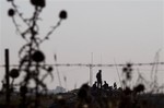 Israeli soldiers stand atop of a tank during a military exercise in the Israeli controlled Golan Heights