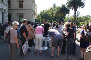 People signing a petition at one of several stalls