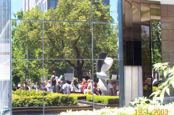 Part of the crowd reflected in the glass