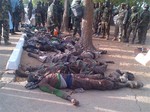 Soldiers looks at bodies of suspected Islamic extremist killed