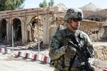 U.S. Army Spc. Joseph Gonzalez, security force team member for Provincial Reconstruction Team Farah, maintains security during a meeting with the Farah provincial chief justice in Farah City, May 4, 2013.