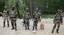 Indian army soldiers search the area after detecting and defusing a bomb on the outskirts of Srinagar, India, Tuesday, April 30, 2013. Indian army in Kashmir Tuesday defused the bomb planted by suspected rebels fighting against Indian rule alongside a highway on the outskirts of the region's main city, the army said.