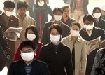 Chinese go to work with masks on the streets of Beijing, China, Thursday, April 24, 2003.