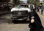 Iraqis gather at the scene of a bomb attack in the commercial area of Karradah in Baghdad, Iraq, Thursday, May 30, 2013.