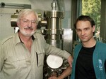 Dr. Heinrich Rohrer from Switzerland, left, and Dr. Gerd Binnig from Frankfurt, West Germany are seen in the IBM laboratry in Rueschlikon, near Zurich, Switzerland, October 15, 1986, standing infront of the scanning tunneling microscope.