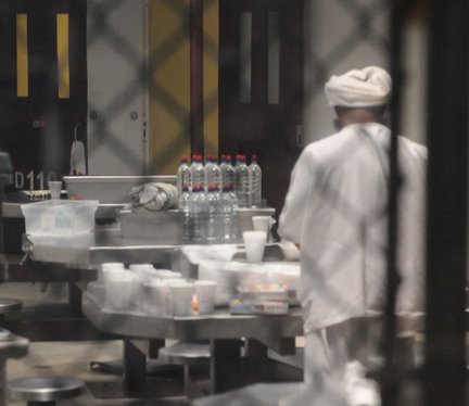 File - A detainee prepares for the mid-day meal at Joint Task Force (JTF) Guantanamo.