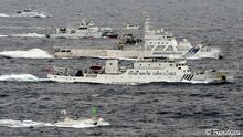 An aerial photo shows a Chinese marine surveillance ship Haijian No. 66 (C) cruising next to Japan Coast Guard patrol ships in the East China Sea, near known as Senkaku isles in Japan and Diaoyu islands in China, in this photo taken by Kyodo April 23, 2013. Japanese nationalists sailed a flotilla of boats on Tuesday in waters near islands at the centre of a row between China and Japan, putting further strain on Tokyo's tense ties with Beijing as a group of more than 160 Japanese lawmakers visited a shrine seen by critics a symbol of Japan's past militarism. Japanese and Chinese patrol ships have been playing a cat-and-mouse game near the Japanese-controlled East China Sea islands, where China is seeking to assert its claim to sovereignty by sending ships into the disputed waters. Mandatory Credit. REUTERS/Kyodo (JAPAN - Tags: POLITICS) FOR EDITORIAL USE ONLY. NOT FOR SALE FOR MARKETING OR ADVERTISING CAMPAIGNS. THIS IMAGE HAS BEEN SUPPLIED BY A THIRD PARTY. IT IS DISTRIBUTED, EXACTLY AS RECEIVED BY REUTERS, AS A SERVICE TO CLIENTS. MANDATORY CREDIT. JAPAN OUT. NO COMMERCIAL OR EDITORIAL SALES IN JAPAN. YES