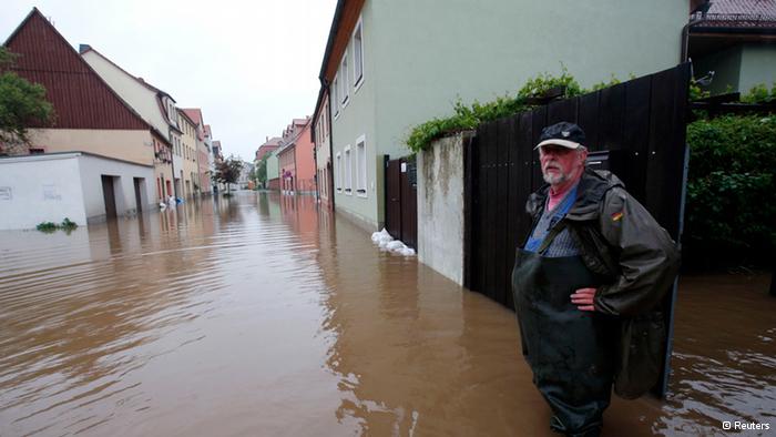 A resident stands at his property on a flooded street in the town of Grimma, near Leipzig June 2, 2013. Authorities in the German state of Saxony have declared Grimma a disaster area, according to local media.(Photo: REUTERS/Fabrizio Bensch)