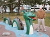 Vanquishing a statue of Ogopogo, the bloodthirsty monster in Lake Okanagan.