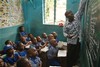 Pupils listen to their teacher at a school in Lagos, Nigeria