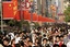 People walk at a shopping street Tuesday, May 1, 2007 in Shanghai, China. May Day, on May 1, is traditionally the day socialist countries honor their workers, but in modern communist China the day kicks off a week-long Golden Week holiday which the government hopes will encourage its citizens to travel and spend, thereby boosting the economy. 