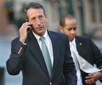 Gov. Mark Sanford speaks on his cell phone near St. Philip's Church in downtown Charleston, S.C. Wednesday Dec. 9, 2009 before talking to the media. A panel of South Carolina lawmakers voted down a measure to impeach Sanford on Wednesday, but recommended a formal rebuke.