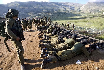 Israeli Soldiers at trampled fence in the Golan