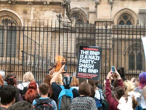 London: Anti-badger-cull folks burning effigy. Anti-fascists joining badger-killer chant