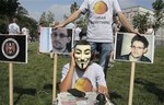 Activists of Ukraine's Internet party, one of them acting as a CIA agent making telephone taps, demand the American authorities stop the pursuit of National Security Agency leaker Edward Snowden at an action of protest near the US Embassy in Kiev, Ukraine, Thursday, June 27, 2013.