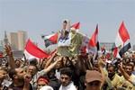 Opponents of Egypt's Islamist President Mohammed Morsi shout slogans as they carry a symbolic coffin of Morsi during a protest in Tahrir Square in Cairo, Egypt, Wednesday, July 3, 2013.