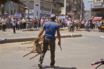 An Egyptian opposition protester holds a chair and knife during a clash between supporters and opponents of President Mohammed Morsi in downtown Damietta, Egypt, Wednesday, July 3, 2013.