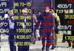 Pedestrians are reflected on a brokerage's electric stock prices board in Tokyo Thursday, April 2, 2009. The benchmark Nikkei 225 stock average rose 251.58 points, or 3.01 percent, to end morning trade at 8,603.49