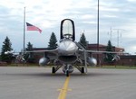 The American flag flies at half-staff in memory of those who perished in the terrorist attack on the World Trade Center and the Pentagon, an F-16 "Fighting Falcon" Air Defense Fighter (ADF), 148th Fighter Wing, Duluth International Airport, Minnesota, sta