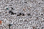 Muslim pilgrims pray outside Namira mosque in Arafat near the holy city of Mecca, Saudi Arabia, Thursday, Oct. 25, 2012.