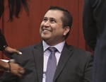 In this image from video, George Zimmerman smiles after a not guilty verdict was handed down in his trial at the Seminole County Courthouse, Sunday, July 14, 2013, in Sanford, Fla.