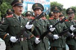 File - Armed Police soldiers of Nanning perform training exercises for visitors at the barrack in southwest China's Guangxi Zhuang Autonomous Region Saturday, July 31, 2004, a day before the Chinese Army Day, the 77th anniversary of the founding of the Chinese People's Liberation Army.