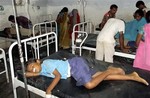 In this Tuesday, July 16, 2013 photo, schoolchildren receive treatment at a hospital after falling ill soon after eating a free meal at a primary school in Chhapra district, in the eastern Indian state of Bihar.