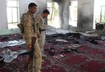 Iraqi army soldiers inspect the damage inside the Abu Bakr Mosque in Baqouba, northeast of Baghdad, Iraq, Friday, July 19, 2013.