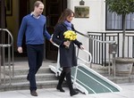 In this Thursday, Dec. 6, 2012 file photo, Britain's Prince William stand next to his wife Kate, Duchess of Cambridge as she leaves the King Edward VII hospital in central London. Prince William and his wife Kate are expecting their first child, and the Duchess of Cambridge was admitted to hospital suffering from a severe form of morning sickness in the early stages of her pregnancy. King Edward VII hospital says a nurse involved in a prank telephone call to elicit information about the Duchess of Cambridge has died.