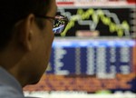 A Filipino trader looks at the graph on a computer at the Philippine Stock Exchange in the financial district of Makati, south of Manila, Philippines on Wednesday Oct. 15, 2008.