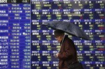 A man walks past Tokyo brokerage's electric signboard indicating Japanese stock prices and other financial information Friday, Jan. 30, 2009. The benchmark Nikkei 225 stock average lost 257.19 points, or 3.1 percent, to 7,994.05 Friday, with a trio of factors rattling investors: an overnight decline on Wall Street, weak economic data and dismal corporate earnings forecasts.