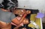 In this Tuesday, July 16, 2013 photo, schoolchildren receive treatment at a hospital after falling ill soon after eating a free meal at a primary school in Chhapra district, in the eastern Indian state of Bihar.