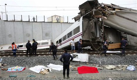 Emergency personnel respond to the scene of a train derailment in Santiago de Compostela, Spain, on Wednesday, July 24, 2013.