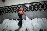 An Egyptian man identifies the body of a supporter of Egypt's ousted President Mohammed Morsi injured who was killed in clashes with security forces at Nasr City, where pro-Morsi protesters have held a weeks-long sit-in, in a field hospital in Cairo, Egypt, Saturday, July 27, 2013.