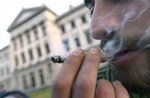 A man smokes marijuana outside the Congress where lawmakers debate a bill to legalize marijuana and regulate production and distribution in Montevideo, Uruguay, Wednesday, July 31, 2013.