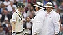 Australia's captain Michael Clarke, left, remonstrates with umpires Tony Hill, right, and Marais Erasmus after play is stopped for bad light on the fourth day of the third Ashes Test series cricket match against England at Old Trafford cricket ground, Manchester, England, Sunday, Aug. 4, 2013. (AP Photo/Jon Super)