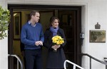 Britain's Prince William stand next to his wife Kate, Duchess of Cambridge as she leaves the King Edward VII hospital in central London, Thursday, Dec. 6, 2012. Prince William and his wife Kate are expecting their first child, and the Duchess of Cambridge was admitted to hospital suffering from a severe form of morning sickness in the early stages of her pregnancy.