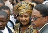  Winnie Madikizela-Mandela, the former wife of Nelson Mandela, center, leaves the high court in Pretoria, South Africa, Monday, July 5, 2004, after winning her appeal against a four-year jail term for alleged theft and fraud. (AP Photo/Themba Hadebe)  (js