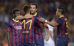 FC Barcelona's Cesc Fabregas, second right, reacts after scoring against Santos with his teammate Neymar, from Brazil, second right, during the Joan Gamper trophy match at the Camp Nou in Barcelona, Spain, Friday, Aug. 2, 2013.