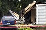 The remains of a plane is seen next to a damaged home after it crashed in East Haven.