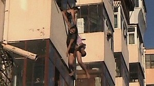 Woman safe after dangling from balcony (Video Thumbnail)