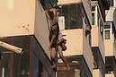 Woman safe after dangling from balcony (Thumbnail)