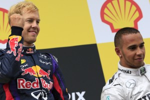 (L to R) Red Bull Racing's German driver Sebastian Vettel and Mercedes'  British driver Lewis Hamilton celebrates on the podium at the Spa-Francorchamps ciruit in Spa on August 25, 2013 after the Belgium Formula One Grand Prix.  AFP PHOTO / ALEXANDER KLEIN